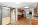 Functional kitchen with wood cabinets, stainless steel appliances, and access to a bright sunroom with sliding glass doors at 3616 Ne 17Th Ln, Ocala, FL 34470