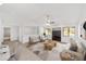 Bright living room with vaulted ceilings, neutral paint, and modern furnishings showcasing a cozy space at 3616 Ne 17Th Ln, Ocala, FL 34470
