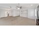 Open-concept living area with neutral carpet and vaulted ceilings, ideal for entertaining guests at 3616 Ne 17Th Ln, Ocala, FL 34470