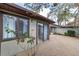 View of patio with gravel, showing access to the interior of the home, surrounded by flora at 3616 Ne 17Th Ln, Ocala, FL 34470