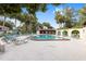 Beautiful community pool surrounded by lush landscaping and lounge chairs at 3616 Ne 17Th Ln, Ocala, FL 34470