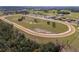 Bird's eye view of horse training facility and grounds with stables and race track at 4695 Ne 112Th Ln, Anthony, FL 32617