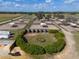 Aerial of horse paddocks and shelters surrounding a central enclosure, offering a well-designed layout and trailer access at 4695 Ne 112Th Ln, Anthony, FL 32617