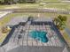 Aerial view of the screened-in pool area with spa and outdoor kitchen at 4695 Ne 112Th Ln, Anthony, FL 32617