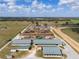 Extensive equestrian estate with barns, paddocks, horse track, and training facilities, set against a backdrop of trees at 4695 Ne 112Th Ln, Anthony, FL 32617