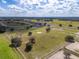 Large horse farm with lush green paddocks, multiple barns, a racetrack, and verdant trees at 4695 Ne 112Th Ln, Anthony, FL 32617