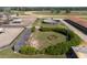 Overhead view features horse paddocks, a training ring, lush landscaping, and stable access in this equestrian facility at 4695 Ne 112Th Ln, Anthony, FL 32617