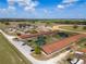 Horse farm aerial highlighting paddocks, barns, horse walkers, and a parking area, showcasing the property's layout and amenities at 4695 Ne 112Th Ln, Anthony, FL 32617