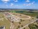 Full aerial shot of equestrian estate with horse track, barns and multiple paddocks at 4695 Ne 112Th Ln, Anthony, FL 32617