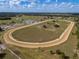Panoramic shot of the horse property, emphasizing the training track and extensive equestrian facilities at 4695 Ne 112Th Ln, Anthony, FL 32617