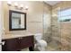 Elegant bathroom featuring a granite vanity, toilet, and tiled glass shower with a window at 4695 Ne 112Th Ln, Anthony, FL 32617