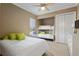 Cozy bedroom features a twin bed, bunk bed, and dresser, complemented by a ceiling fan and natural light at 4695 Ne 112Th Ln, Anthony, FL 32617