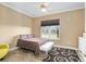 Comfortable bedroom with a large window offering natural light and pleasant views of the exterior at 4695 Ne 112Th Ln, Anthony, FL 32617