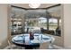 Bright dining area featuring large windows overlooking the pool and patio at 4695 Ne 112Th Ln, Anthony, FL 32617