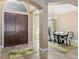 Elegant foyer with double doors leading to a dining room with a decorative chandelier at 4695 Ne 112Th Ln, Anthony, FL 32617
