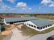 Aerial view of horse stables featuring multiple stalls, verdant surroundings and blue skies at 4695 Ne 112Th Ln, Anthony, FL 32617