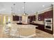 Well-appointed kitchen with a large island, bar seating, stainless steel appliances, and plenty of storage at 4695 Ne 112Th Ln, Anthony, FL 32617