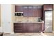 Modern kitchenette features custom cabinets, granite countertops, and stainless steel appliances at 4695 Ne 112Th Ln, Anthony, FL 32617