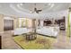 Open-concept living space showcasing white sofas, stylish rug, and seamless flow to the dining and kitchen areas at 4695 Ne 112Th Ln, Anthony, FL 32617