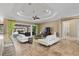 Bright living room featuring modern white sofas, decorative rug and ceiling, and access to the outdoor pool area at 4695 Ne 112Th Ln, Anthony, FL 32617
