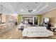 Bright and airy living room with white sofas, view of the outdoor pool, and an open floorplan into the kitchen at 4695 Ne 112Th Ln, Anthony, FL 32617