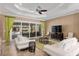 Bright living room with a ceiling fan, pool view, and modern furnishings at 4695 Ne 112Th Ln, Anthony, FL 32617