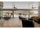 Expansive covered patio featuring travertine floors, ceiling fans, and comfortable seating overlooking a pool at 4695 Ne 112Th Ln, Anthony, FL 32617