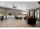 Spacious covered patio with travertine floors, comfortable seating, ceiling fans, and views of the pool area at 4695 Ne 112Th Ln, Anthony, FL 32617
