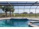 Screened-in pool area with chairs and spa at 4695 Ne 112Th Ln, Anthony, FL 32617