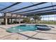 Screened-in pool area with spa and outdoor kitchen/entertaining area at 4695 Ne 112Th Ln, Anthony, FL 32617