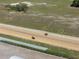 Aerial shot of horses racing on a well-maintained track with a rider at 4695 Ne 112Th Ln, Anthony, FL 32617