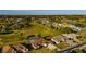 Community aerial view featuring golf course, lush green spaces, and residences with screened pools at 5115 Nw 21St Loop, Ocala, FL 34482