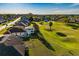 Aerial view of residences alongside a golf course with well-maintained lawns and screened pools at 5115 Nw 21St Loop, Ocala, FL 34482