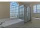 Bathroom featuring a glass block window and a shower stall at 5115 Nw 21St Loop, Ocala, FL 34482