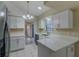 Modern kitchen featuring white cabinets, quartz countertops, and stainless steel appliances at 5115 Nw 21St Loop, Ocala, FL 34482