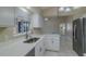 Bright kitchen featuring white cabinetry, quartz countertops, stainless steel appliances, and natural light at 5115 Nw 21St Loop, Ocala, FL 34482