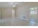 Spacious room featuring ceramic tile floors, ceiling fan, and neutral paint, offering a versatile living space at 5115 Nw 21St Loop, Ocala, FL 34482