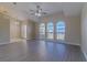 Vaulted living room with luxury vinyl plank flooring, ceiling fan, and arched windows providing ample natural light at 5115 Nw 21St Loop, Ocala, FL 34482