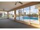 Enclosed carpeted patio with ceiling fans and views of the pool at 5115 Nw 21St Loop, Ocala, FL 34482