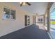 Enclosed carpeted patio with multiple ceiling fans and exterior access at 5115 Nw 21St Loop, Ocala, FL 34482