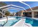 The screened in pool area offers both a pool and hot tub for outdoor enjoyment and relaxation at 5115 Nw 21St Loop, Ocala, FL 34482