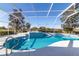 The clear blue pool is screened in for extended season use and features an attached hot tub at 5115 Nw 21St Loop, Ocala, FL 34482