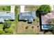 Aerial view of house, backyard, mature trees, and fenced perimeter at 5347 Nw 20Th Pl, Ocala, FL 34482