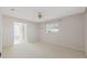 Large bedroom boasts bathroom access, carpet floors, and ample sunlight through large window at 5347 Nw 20Th Pl, Ocala, FL 34482