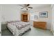 Cozy bedroom with quilt-covered bed, wooden armoire, and a sunny window, creating a warm, inviting space at 5347 Nw 20Th Pl, Ocala, FL 34482
