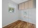 Bonus room features ample sunlight, wood floor, ceiling cabinets and ladder for extra storage at 5347 Nw 20Th Pl, Ocala, FL 34482