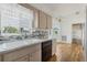 Kitchen featuring a new sink, stylish backsplash, and white cabinets at 5347 Nw 20Th Pl, Ocala, FL 34482