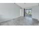 Bright living room featuring contemporary flooring and sliding glass doors to sunroom at 5347 Nw 20Th Pl, Ocala, FL 34482
