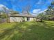 View of back exterior of house with sliding glass doors leading to large backyard at 5520 Nw 57Th St, Ocala, FL 34482
