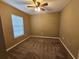 Comfortable carpeted bedroom with ceiling fan and a window offering a relaxing private space at 5520 Nw 57Th St, Ocala, FL 34482